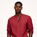 Man wearing a red linen shirt and white pants