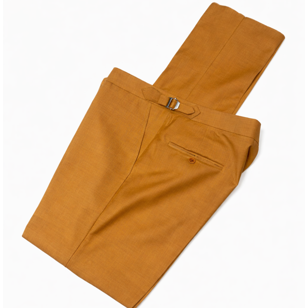 Folded mustard yellow pants with size metal clips
